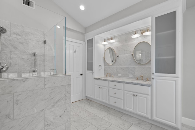 919 Aleeda Ln, Santa Barbara, CA 93108 - bathroom with vaulted ceiling, a shower stall, double vanity, and marble look tile flooring