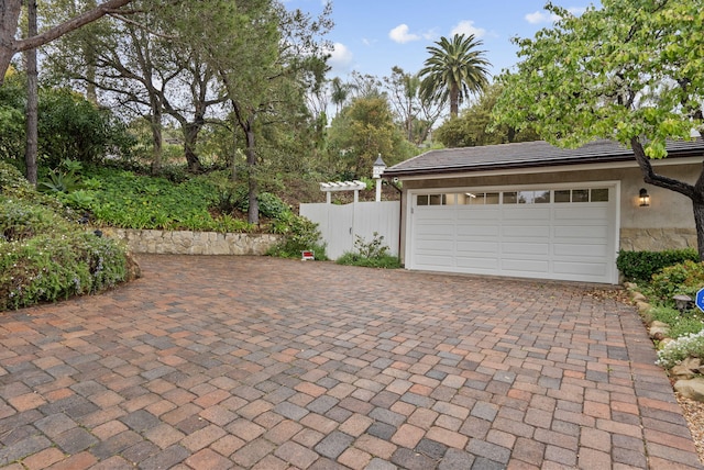 919 Aleeda Ln, Santa Barbara, CA 93108 - garage featuring decorative driveway and fence