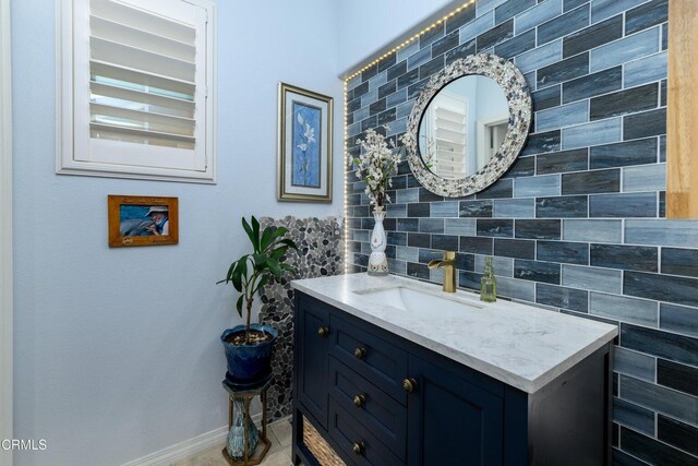 714 Nile River Dr, Oxnard, CA 93036 - bathroom with baseboards, tasteful backsplash, and vanity