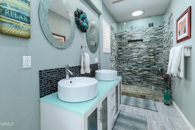 714 Nile River Dr, Oxnard, CA 93036 - full bathroom featuring backsplash, a tile shower, double vanity, and baseboards