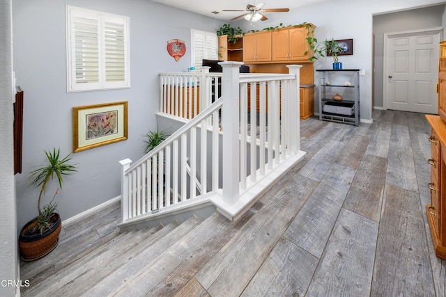 714 Nile River Dr, Oxnard, CA 93036 - staircase with hardwood / wood-style floors, a ceiling fan, and baseboards