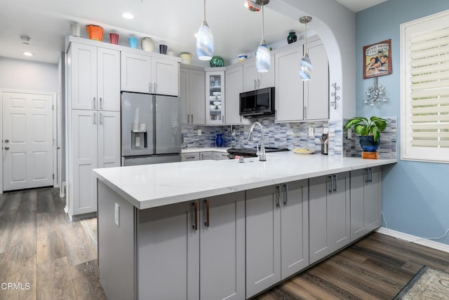 714 Nile River Dr, Oxnard, CA 93036 - kitchen featuring stainless steel refrigerator with ice dispenser, a peninsula, gray cabinetry, dark wood-type flooring, and decorative backsplash