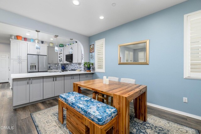 714 Nile River Dr, Oxnard, CA 93036 - dining space featuring dark wood finished floors, recessed lighting, baseboards, and arched walkways