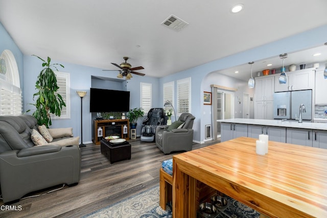 714 Nile River Dr, Oxnard, CA 93036 - living area with dark wood-type flooring, a ceiling fan, recessed lighting, baseboards, and arched walkways