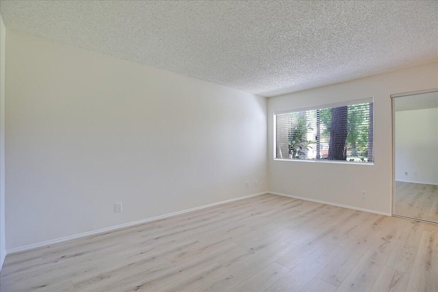 232 Rosewood St, Ventura, CA 93001 - unfurnished room with light wood-type flooring, a textured ceiling, and baseboards