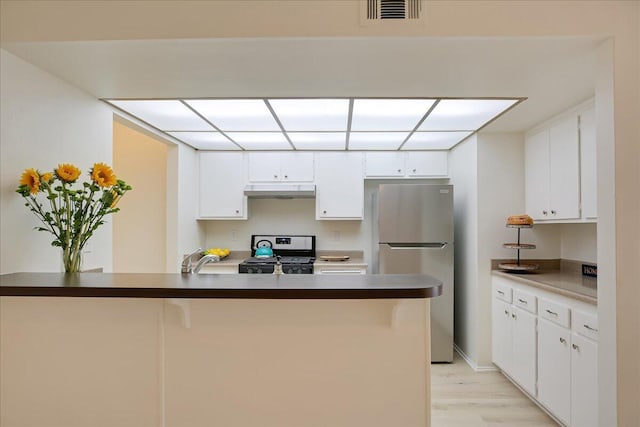 232 Rosewood St, Ventura, CA 93001 - kitchen featuring appliances with stainless steel finishes, under cabinet range hood, light wood-type flooring, and white cabinetry