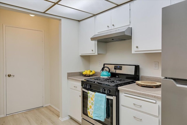 232 Rosewood St, Ventura, CA 93001 - kitchen featuring under cabinet range hood, stainless steel appliances, light wood-type flooring, light countertops, and white cabinetry