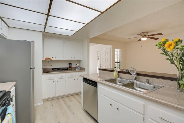 232 Rosewood St, Ventura, CA 93001 - kitchen with stainless steel appliances, a sink, light wood finished floors, white cabinetry, and light countertops