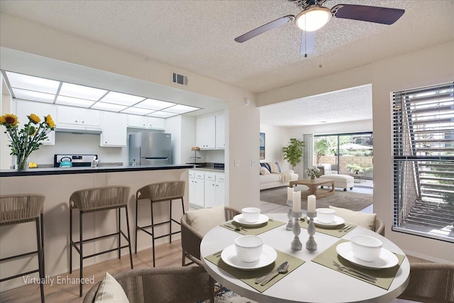 232 Rosewood St, Ventura, CA 93001 - dining room featuring a textured ceiling, light wood-type flooring, and ceiling fan