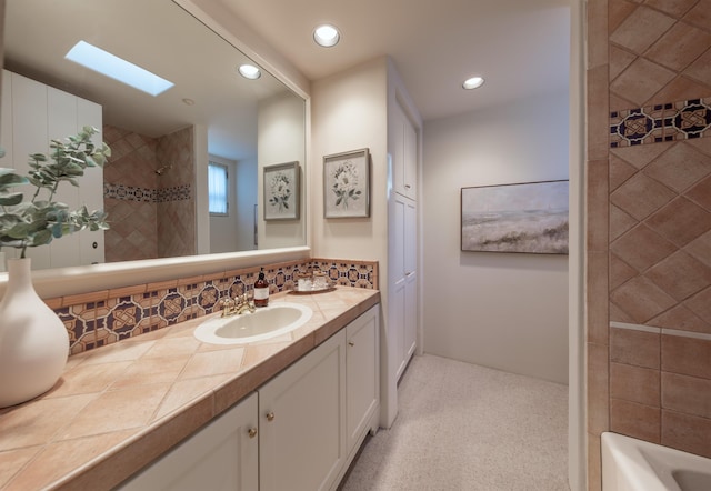 603 Juan Crespi Ln, Montecito, CA 93108 - bathroom featuring vanity, recessed lighting, tasteful backsplash, and a skylight