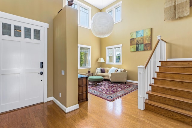 5049 Via Lara Ln, Santa Barbara, CA 93111 - entrance foyer featuring wood finished floors, a high ceiling, healthy amount of natural light, baseboards, and stairway