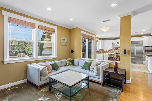 5049 Via Lara Ln, Santa Barbara, CA 93111 - living area featuring plenty of natural light, recessed lighting, baseboards, and ornamental molding