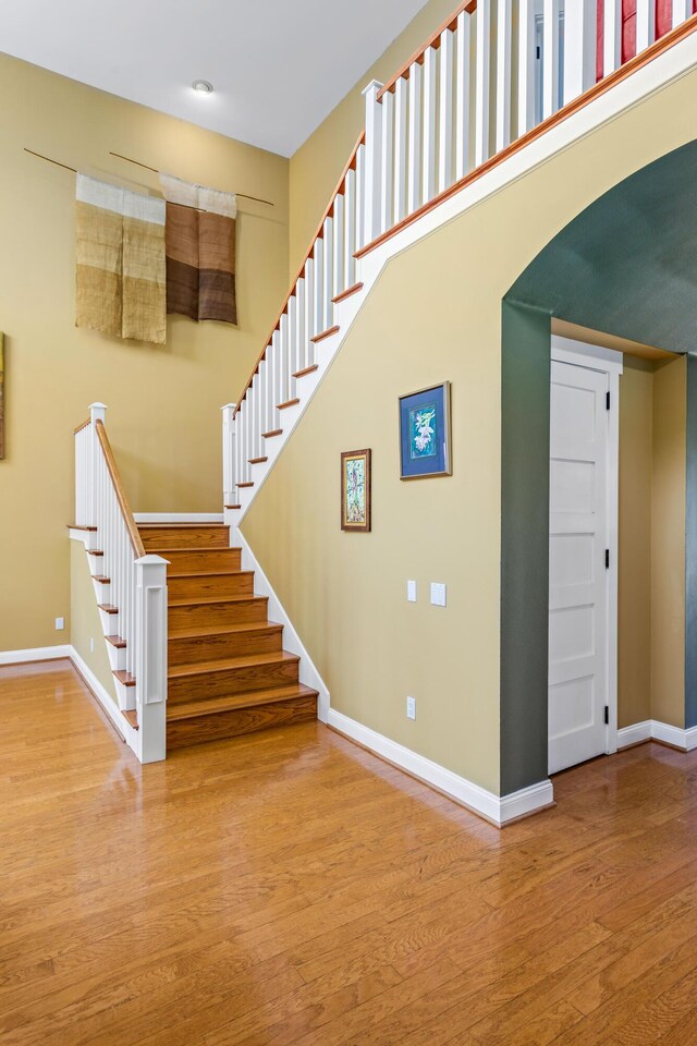 5049 Via Lara Ln, Santa Barbara, CA 93111 - staircase with baseboards, wood finished floors, and arched walkways