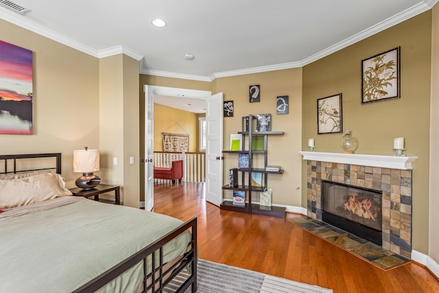 5049 Via Lara Ln, Santa Barbara, CA 93111 - bedroom with wood finished floors, ornamental molding, baseboards, a tile fireplace, and recessed lighting
