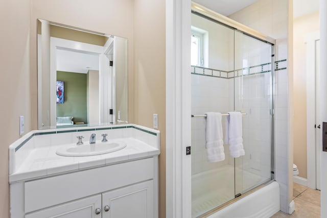 5049 Via Lara Ln, Santa Barbara, CA 93111 - full bath featuring ensuite bathroom, toilet, vanity, tile patterned flooring, and combined bath / shower with glass door