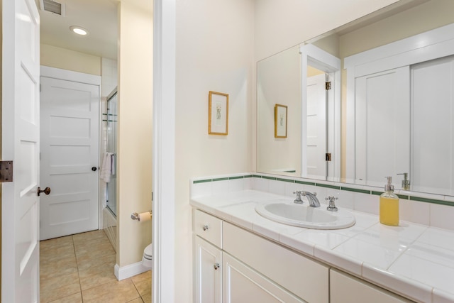 5049 Via Lara Ln, Santa Barbara, CA 93111 - bathroom featuring tile patterned floors, toilet, vanity, bath / shower combo with glass door, and recessed lighting