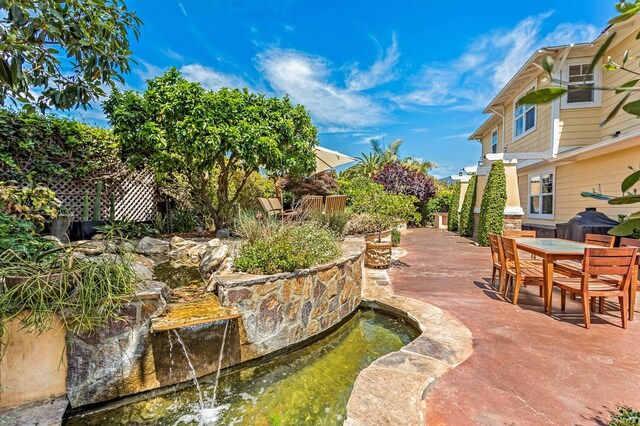 5049 Via Lara Ln, Santa Barbara, CA 93111 - view of patio / terrace featuring outdoor dining space and a garden pond