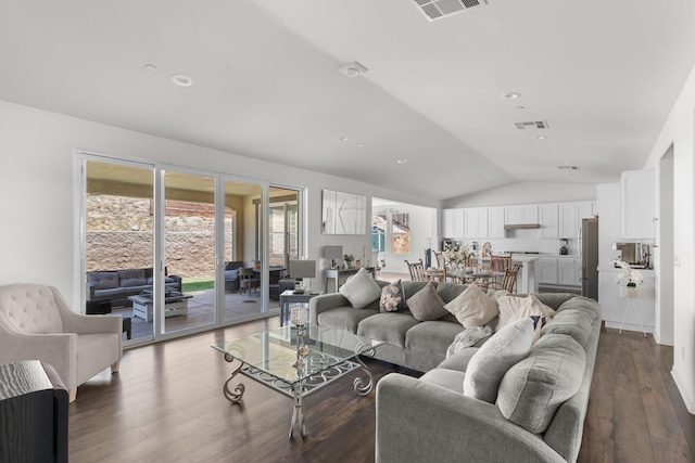 living room with lofted ceiling and dark wood-type flooring