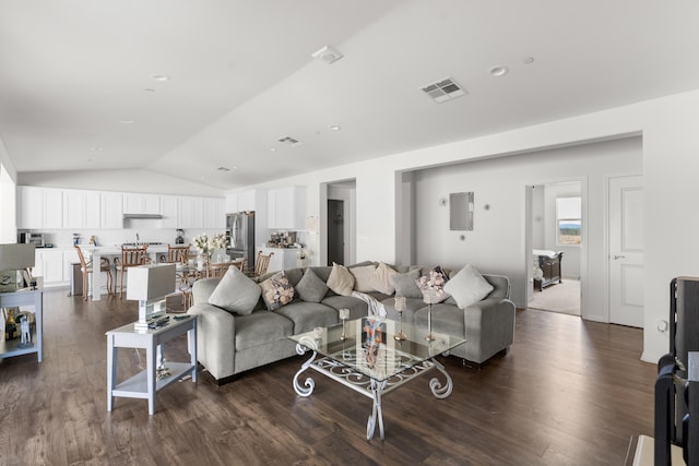 living room featuring vaulted ceiling and dark wood-style floors