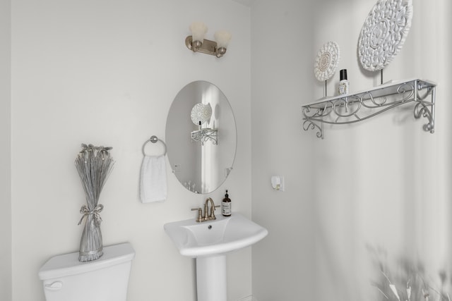 bathroom with toilet and a sink
