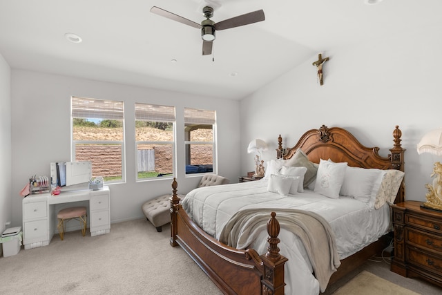 carpeted bedroom featuring lofted ceiling and ceiling fan