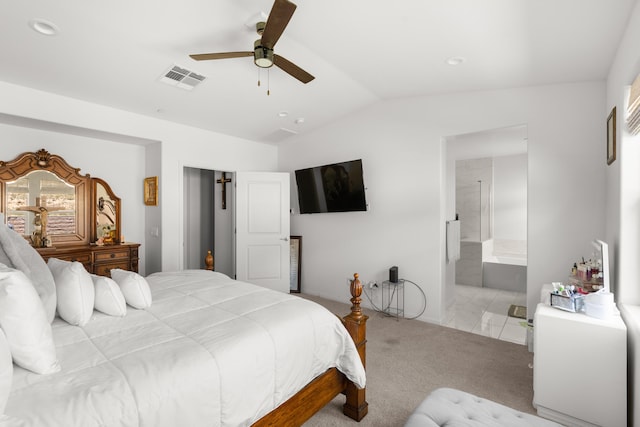 bedroom with vaulted ceiling, carpet floors, a ceiling fan, and ensuite bathroom