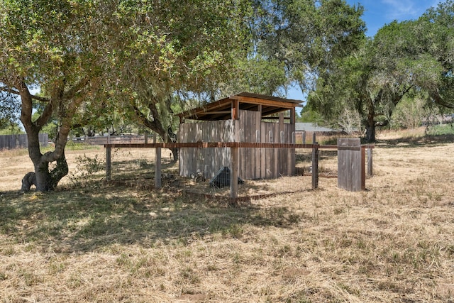 view of yard featuring fence and an outdoor structure