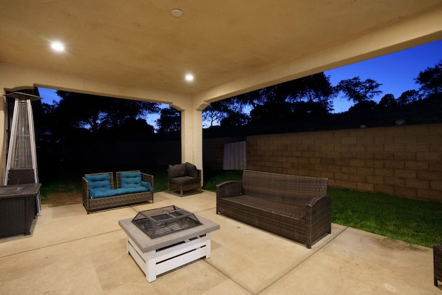 view of patio with an outdoor living space with a fire pit and a fenced backyard