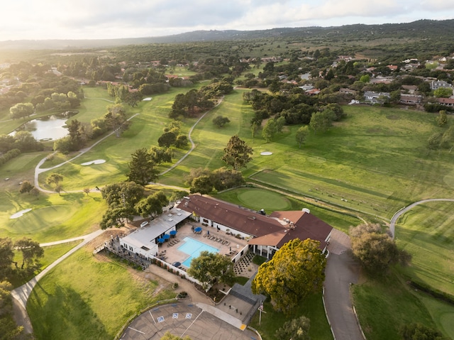 view of property location with a large body of water, a golf club, and a pool