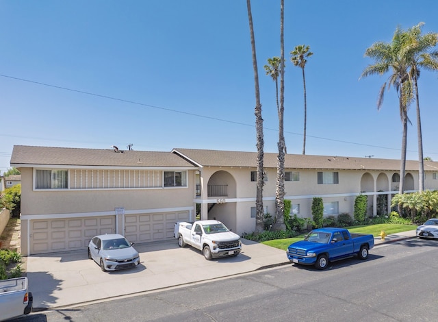 560 W Gonzales Rd, Oxnard, CA 93030 - view of front of property with stucco siding, an attached garage, and concrete driveway