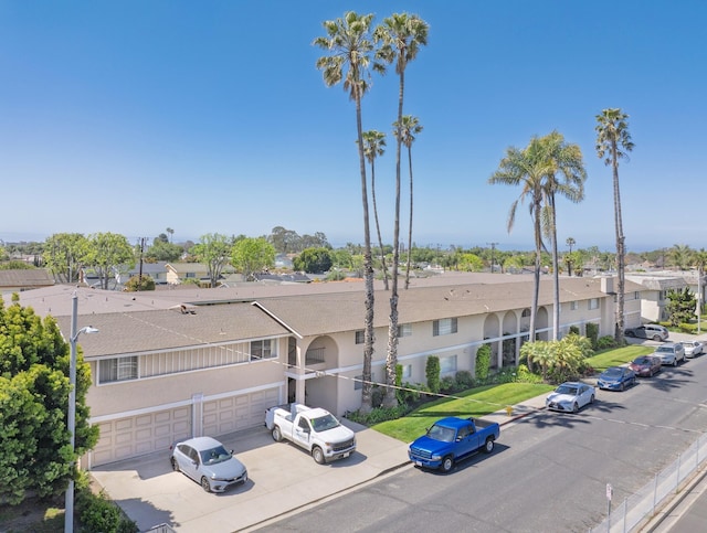 560 W Gonzales Rd, Oxnard, CA 93030 - view of property with driveway, an attached garage, and a residential view