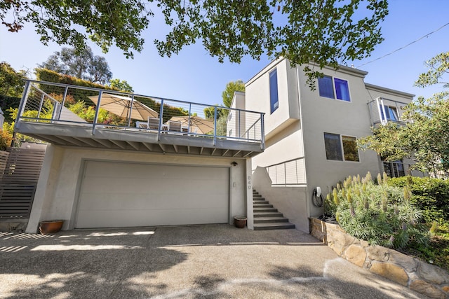 840 Cheltenham Rd, Santa Barbara, CA 93105 - view of front facade featuring stucco siding, a balcony, stairway, a garage, and driveway