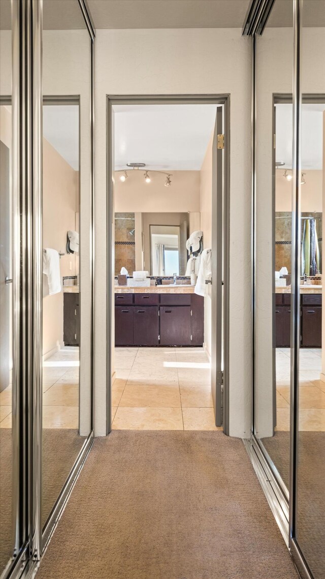 840 Cheltenham Rd, Santa Barbara, CA 93105 - corridor with light carpet, light tile patterned floors, and a sink