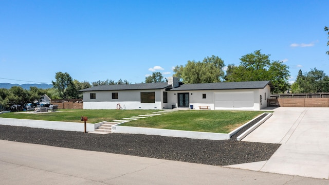 1311 Meadowvale Rd, Santa Ynez, CA 93460 - single story home featuring concrete driveway, a garage, stucco siding, a mountain view, and a chimney