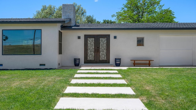 1311 Meadowvale Rd, Santa Ynez, CA 93460 - view of exterior entry with french doors, a lawn, stucco siding, and a chimney