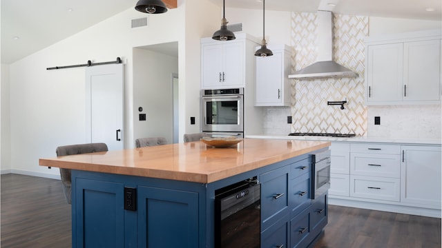 1311 Meadowvale Rd, Santa Ynez, CA 93460 - kitchen featuring wall chimney range hood, lofted ceiling, built in microwave, wooden counters, and white cabinets