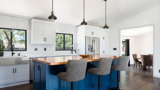 1311 Meadowvale Rd, Santa Ynez, CA 93460 - kitchen with stainless steel fridge, a sink, butcher block counters, plenty of natural light, and vaulted ceiling