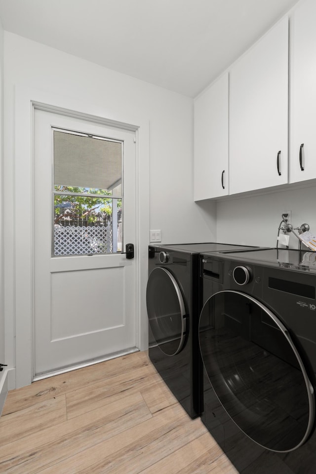 246 3rd St, Solvang, CA 93463 - laundry area featuring cabinet space, washing machine and clothes dryer, and light wood finished floors
