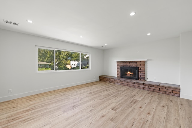 246 3rd St, Solvang, CA 93463 - unfurnished living room featuring wood finished floors, recessed lighting, a brick fireplace, and baseboards