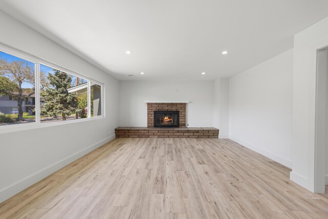 246 3rd St, Solvang, CA 93463 - unfurnished living room with light wood-type flooring, recessed lighting, baseboards, and a brick fireplace