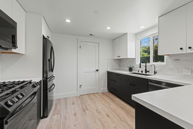 246 3rd St, Solvang, CA 93463 - kitchen featuring black appliances, a sink, light wood-type flooring, light countertops, and recessed lighting