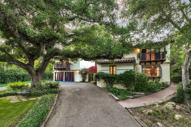 725 Ashley Rd, Montecito, CA 93108 - view of front facade with a balcony, stucco siding, and asphalt driveway