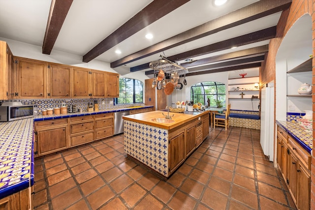 725 Ashley Rd, Montecito, CA 93108 - kitchen featuring stainless steel appliances, wood counters, tasteful backsplash, healthy amount of natural light, and beamed ceiling