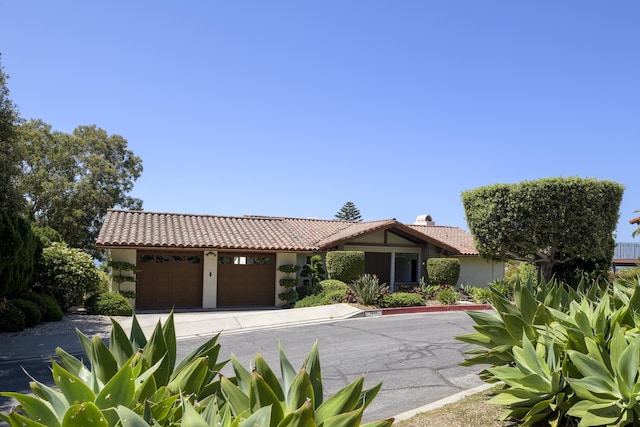 1649 Miramesa Dr, Santa Barbara, CA 93109 - view of front of property featuring an attached garage, stucco siding, a tiled roof, and concrete driveway