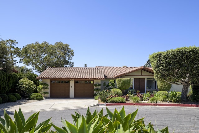 1649 Miramesa Dr, Santa Barbara, CA 93109 - view of front facade featuring a tiled roof, driveway, an attached garage, and stucco siding