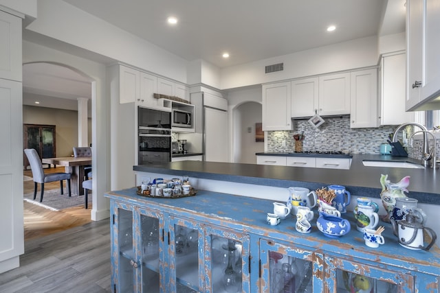 4477 Shadow Hills Blvd Unit A, Santa Barbara, CA 93105 - kitchen featuring arched walkways, a sink, dark countertops, appliances with stainless steel finishes, and recessed lighting