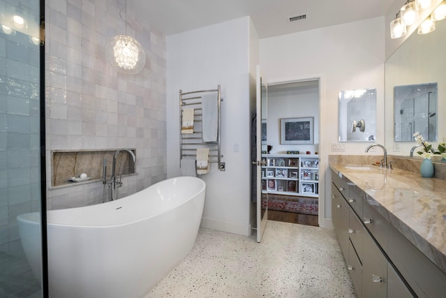 4477 Shadow Hills Blvd Unit A, Santa Barbara, CA 93105 - full bathroom with speckled floor, vanity, a freestanding tub, baseboards, and a towel warming rack