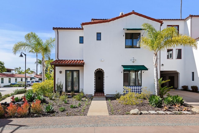 3736 State St Unit 109, Santa Barbara, CA 93105 - mediterranean / spanish house with french doors, a tile roof, and stucco siding