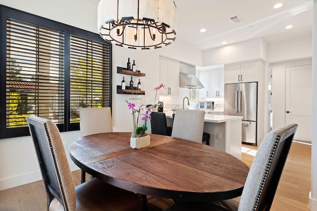 3736 State St Unit 109, Santa Barbara, CA 93105 - dining area with a chandelier, light wood finished floors, recessed lighting, and baseboards