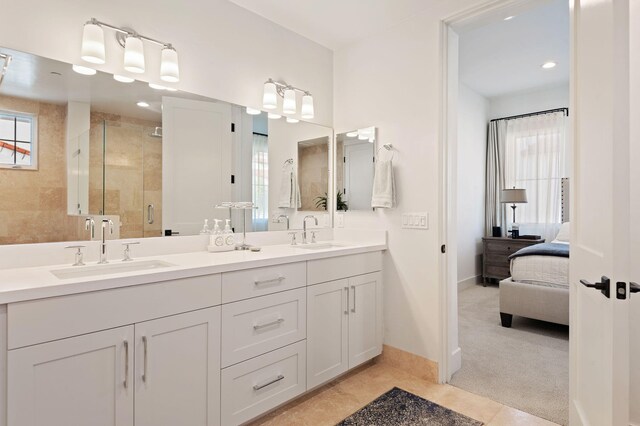 3736 State St Unit 109, Santa Barbara, CA 93105 - ensuite bathroom with a shower stall, baseboards, double vanity, and recessed lighting